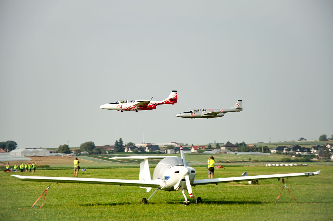 Multiple aircraft on a runway under clear skies, showcasing aviation and travel.